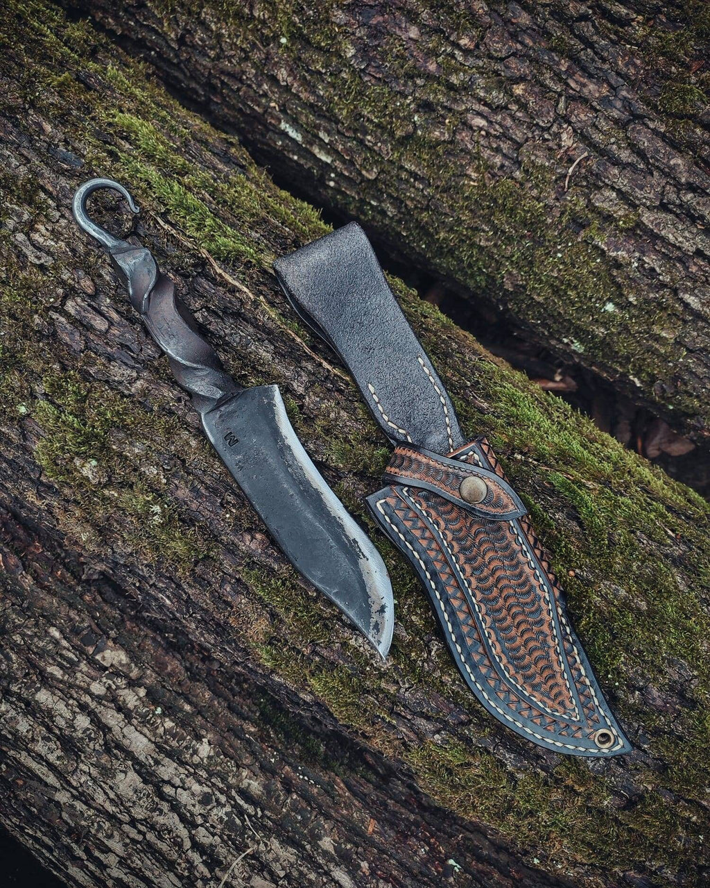 Blacksmith hand forged primitive style custom carbon steel knife with leather sheath