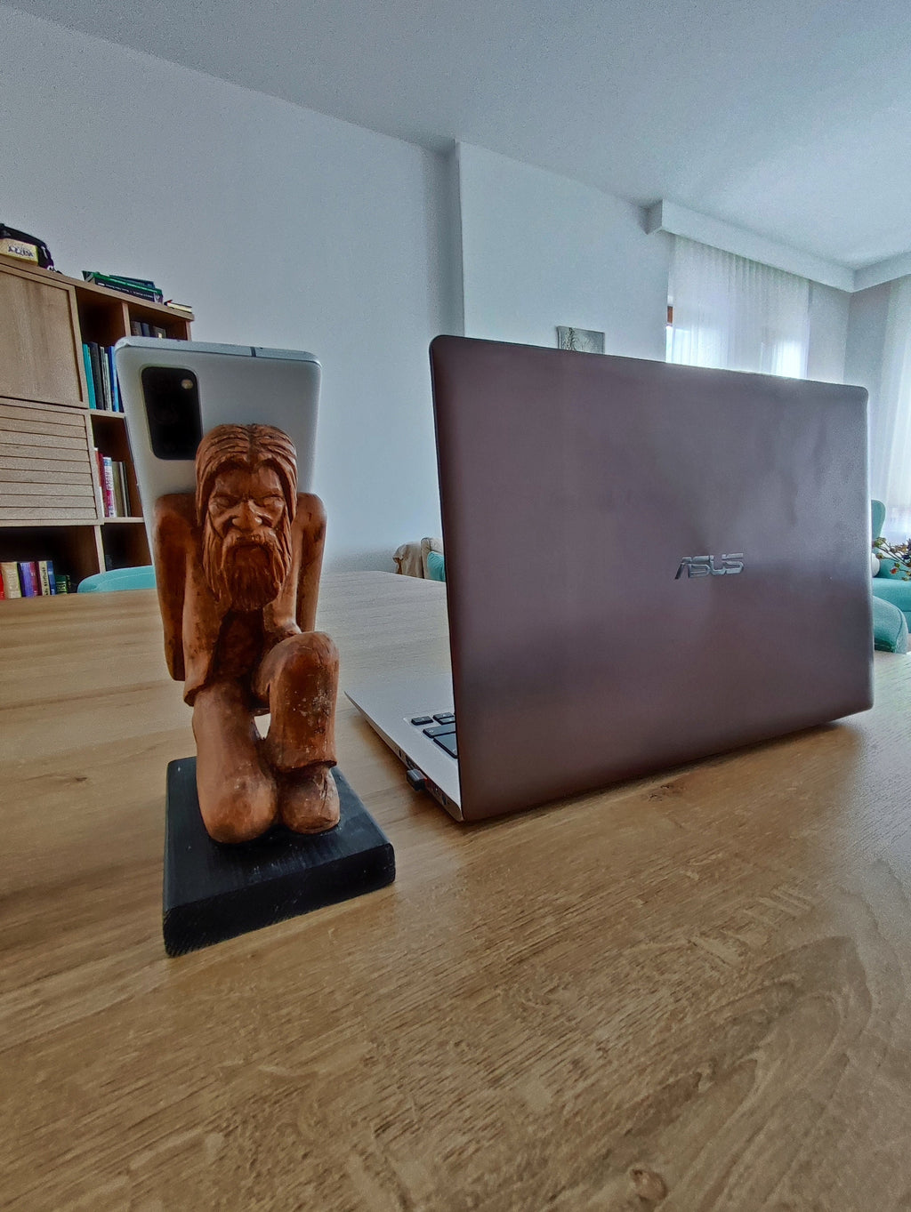 The Burden on Technology's Shoulders: Wooden Elder and Smartphone Stand