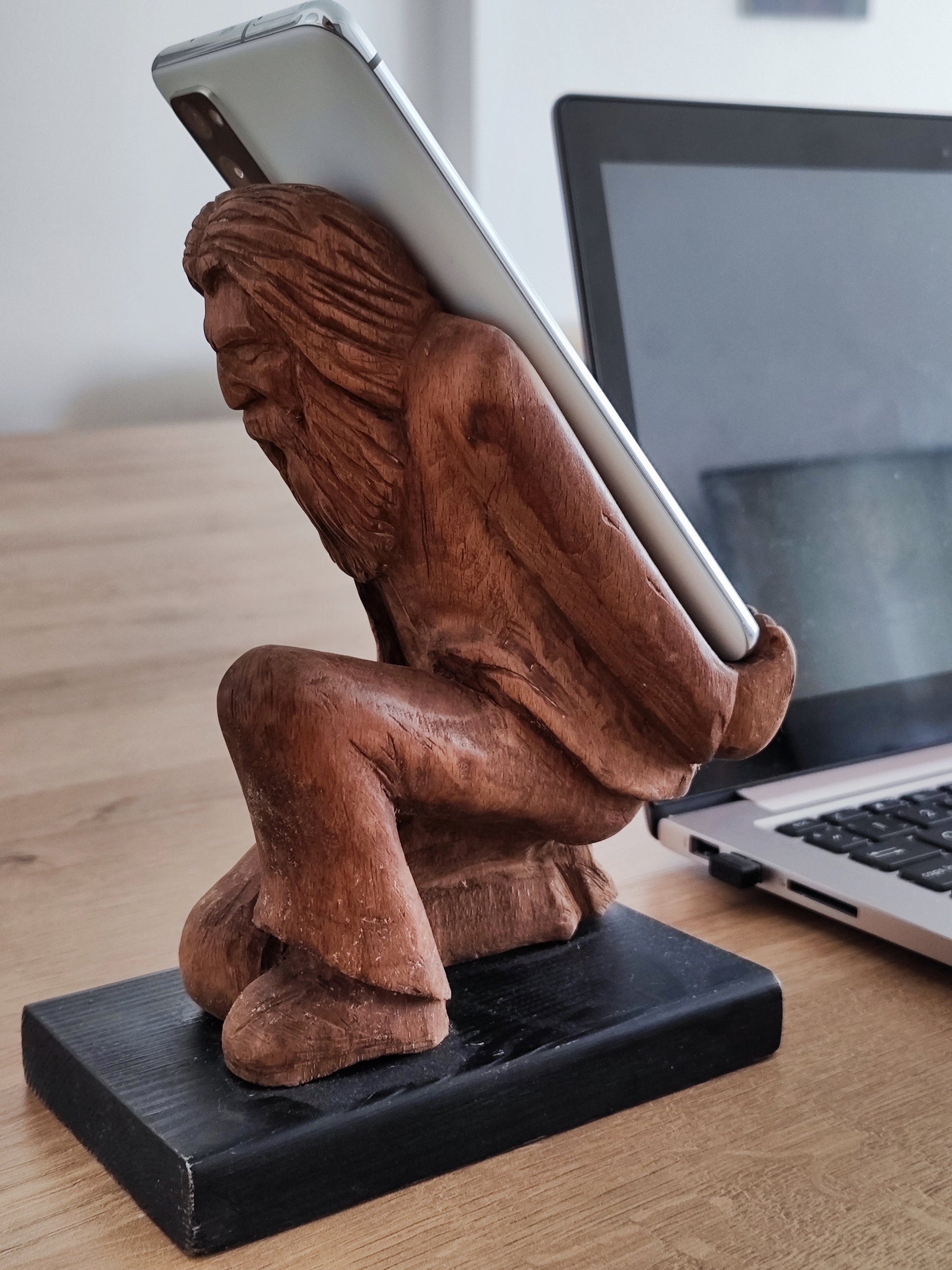 The Burden on Technology's Shoulders: Wooden Elder and Smartphone Stand
