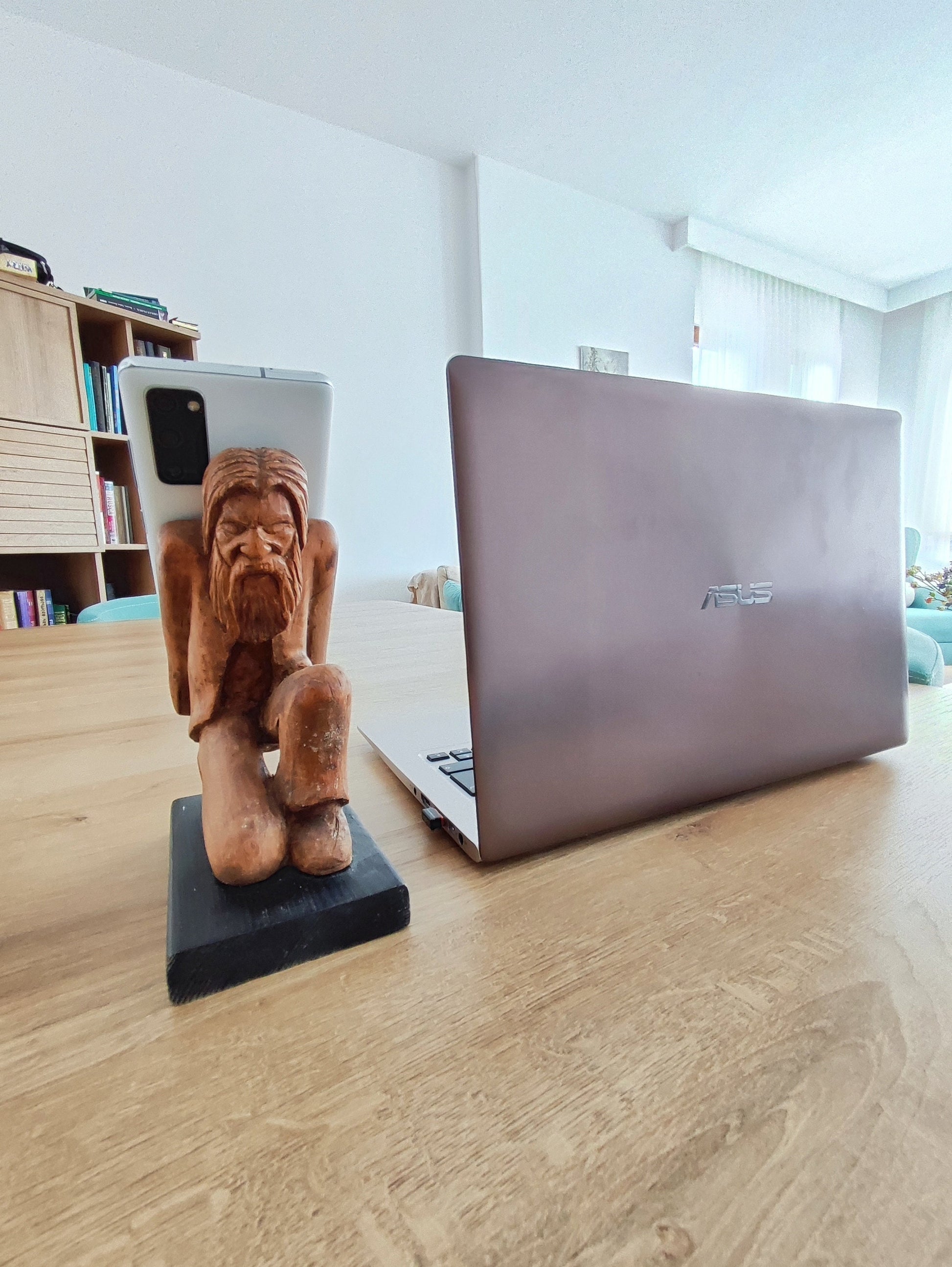 The Burden on Technology's Shoulders: Wooden Elder and Smartphone Stand
