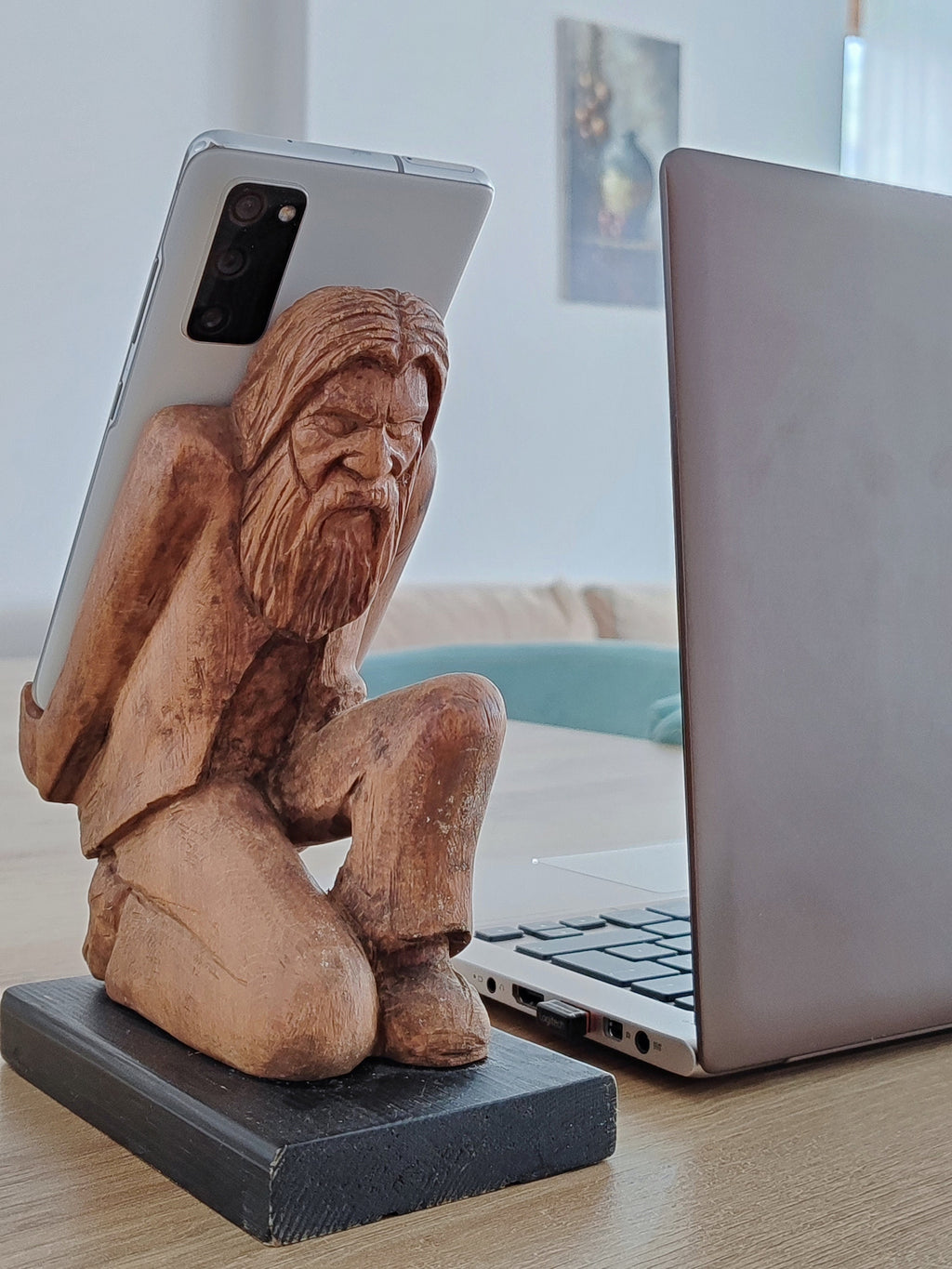 The Burden on Technology's Shoulders: Wooden Elder and Smartphone Stand