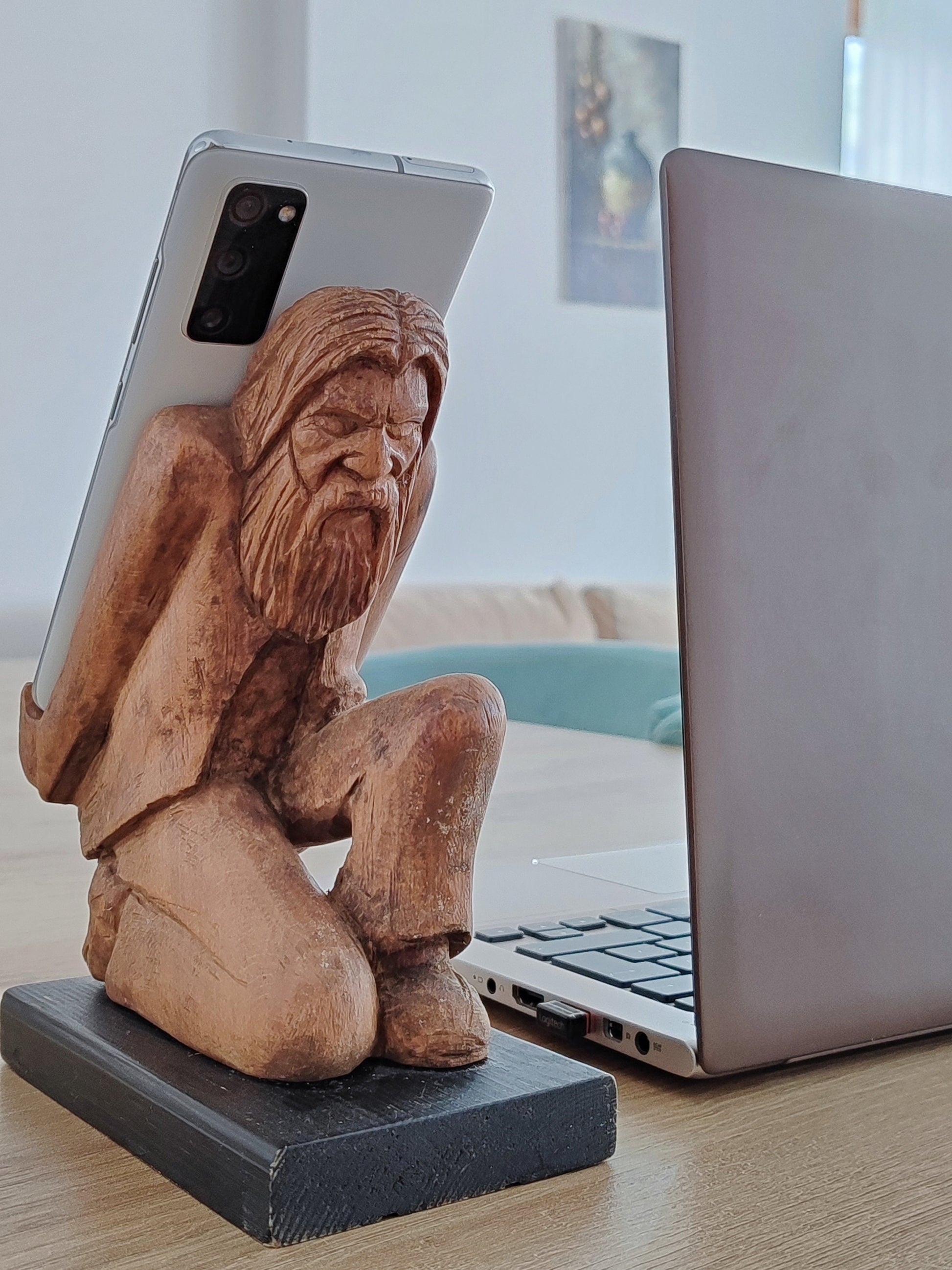The Burden on Technology's Shoulders: Wooden Elder and Smartphone Stand