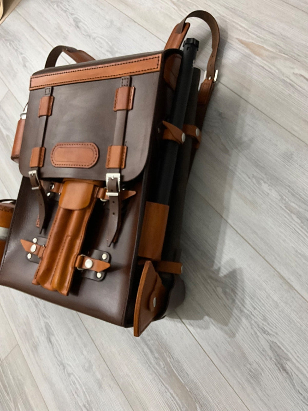 Handmade leather bushcraft bag a bushcraft axe, handmade folding pan, aluminum water carrier, camping pot, bushcraft drill, and bowsaw